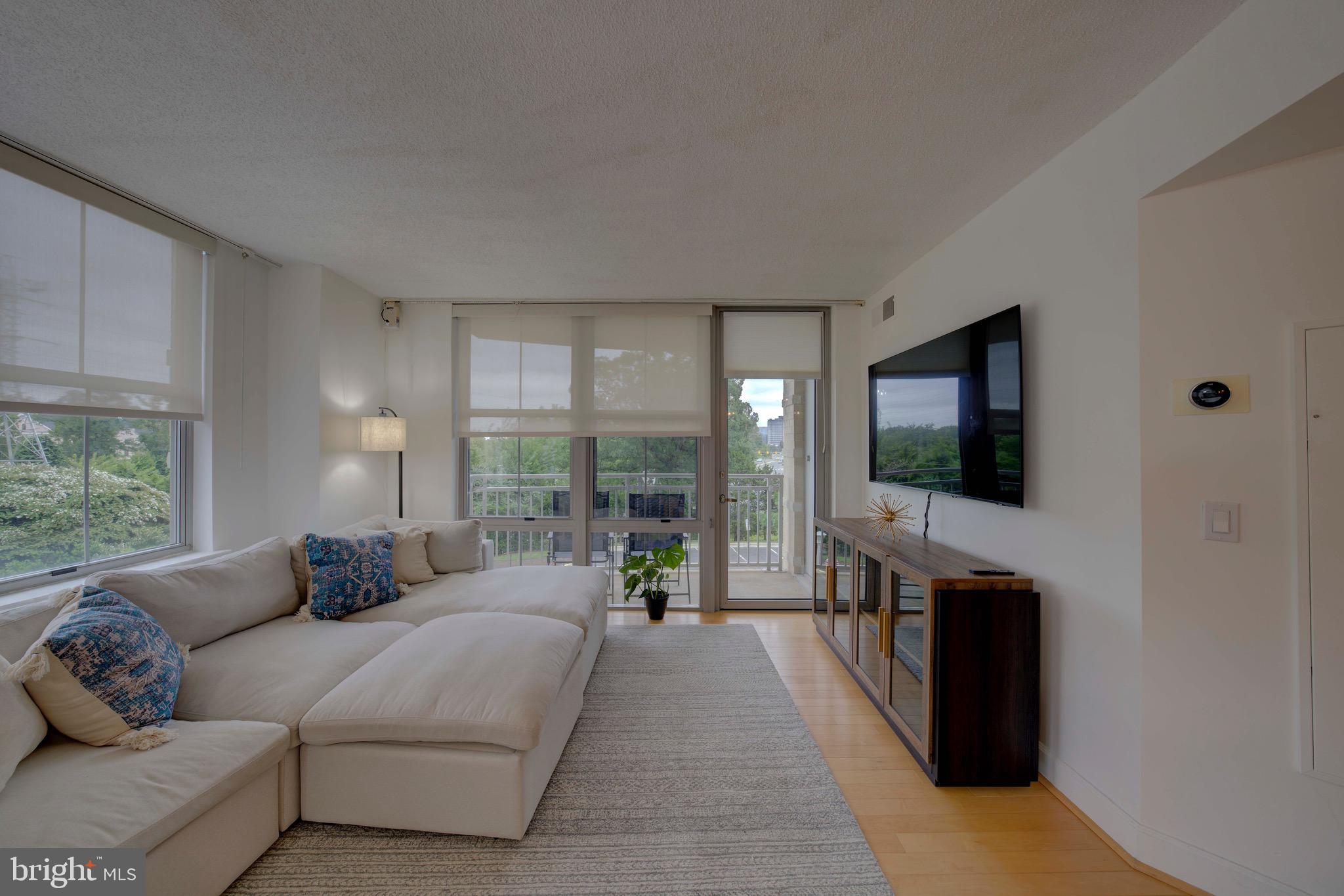 11800 Sunset Hills Road, Unit 222 Reston, VA 20190 - Photo 12 of 70 a living room with furniture and a flat screen tv