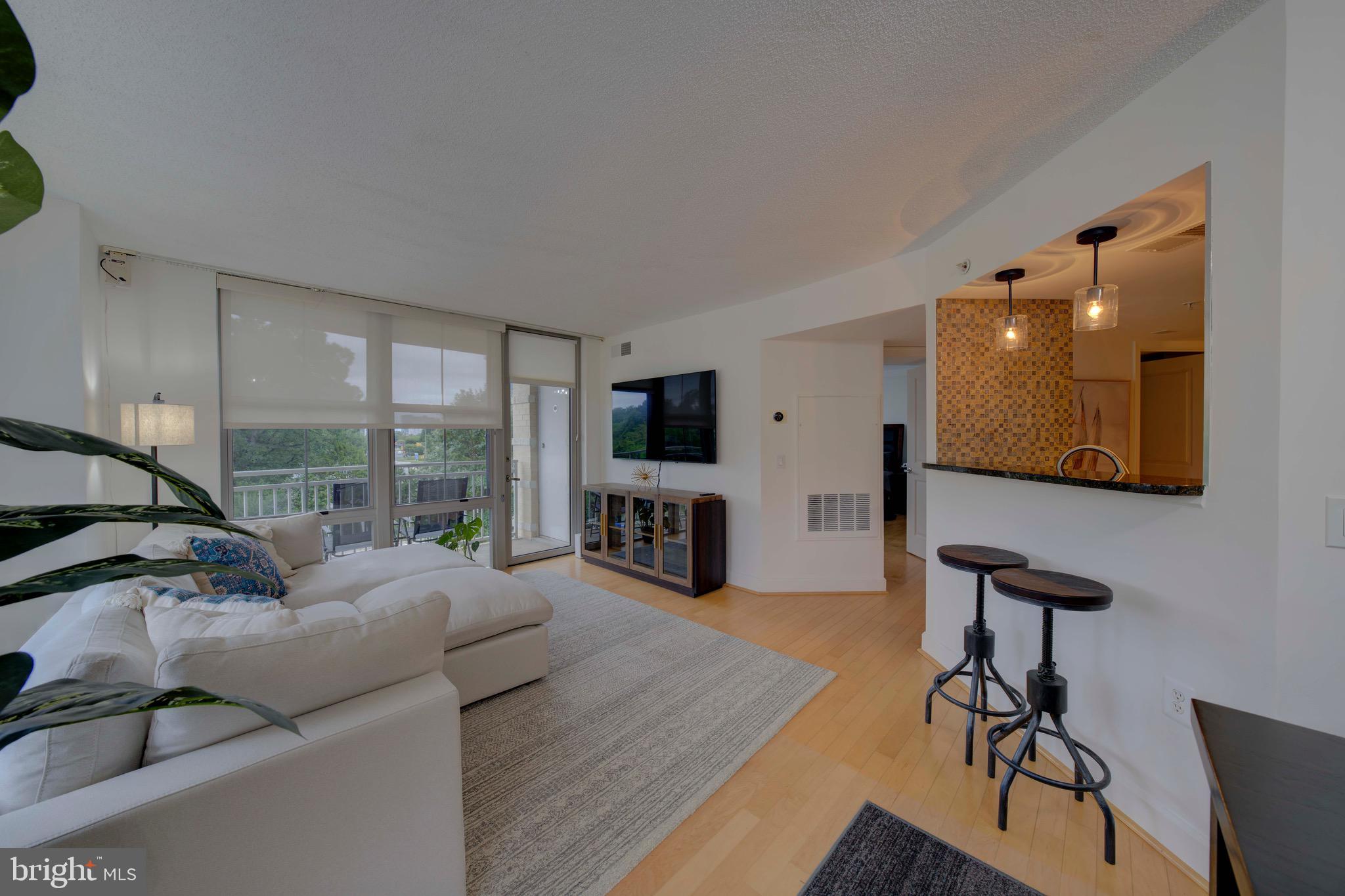 11800 Sunset Hills Road, Unit 222 Reston, VA 20190 - Photo 14 of 70 a living room with furniture and a flat screen tv