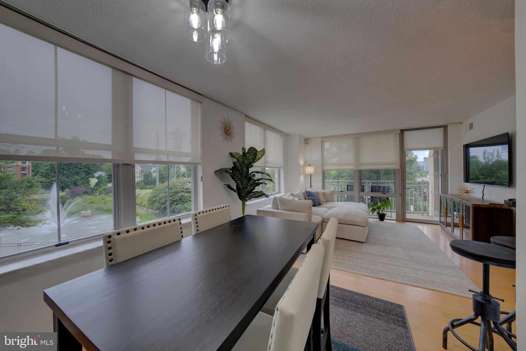 11800 Sunset Hills Road, Unit 222 Reston, VA 20190 - Photo 17 of 70 a living room with furniture a large window and a flat screen tv