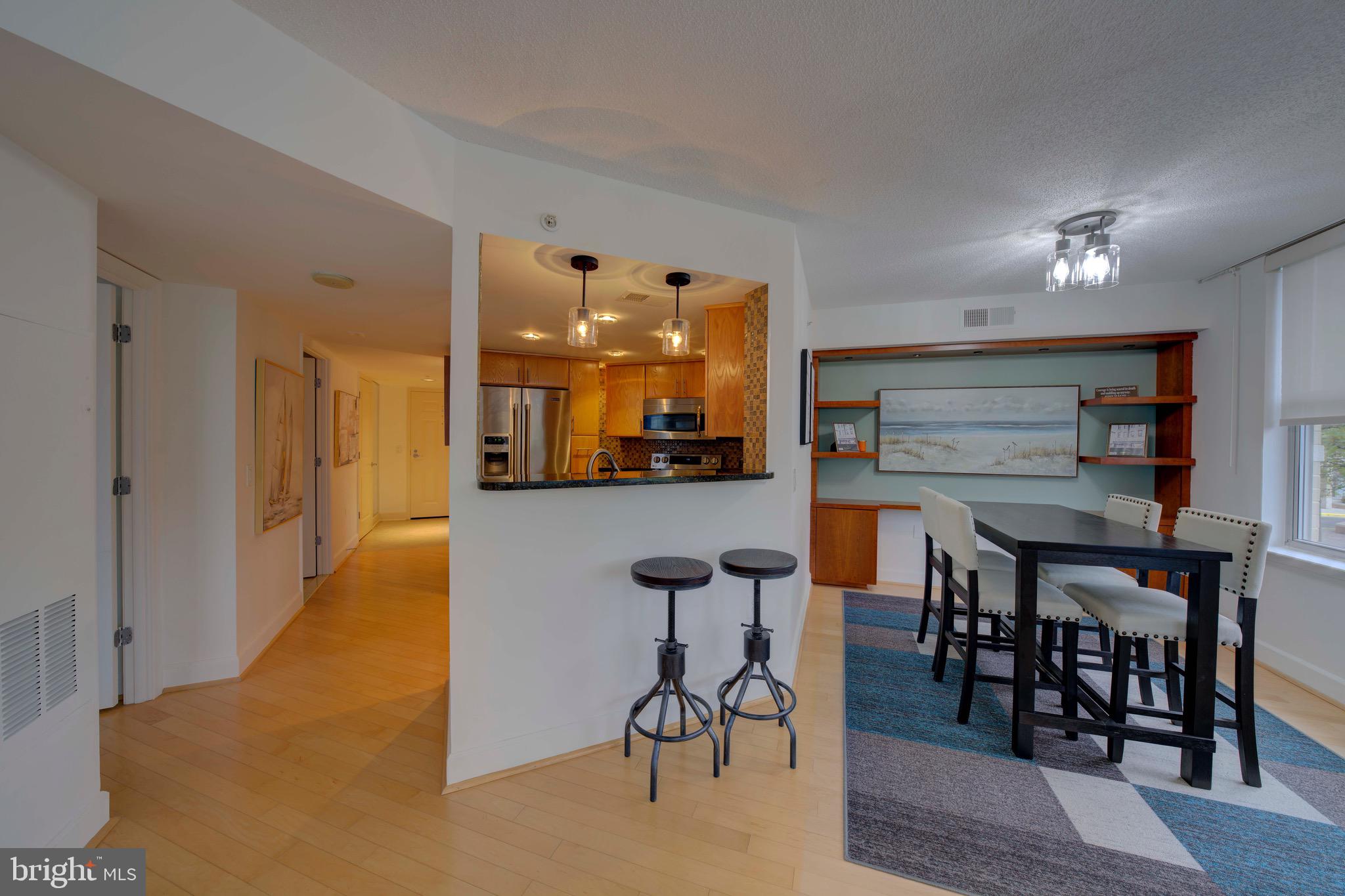 11800 Sunset Hills Road, Unit 222 Reston, VA 20190 - Photo 21 of 70 a view of a dining room with furniture and wooden floor