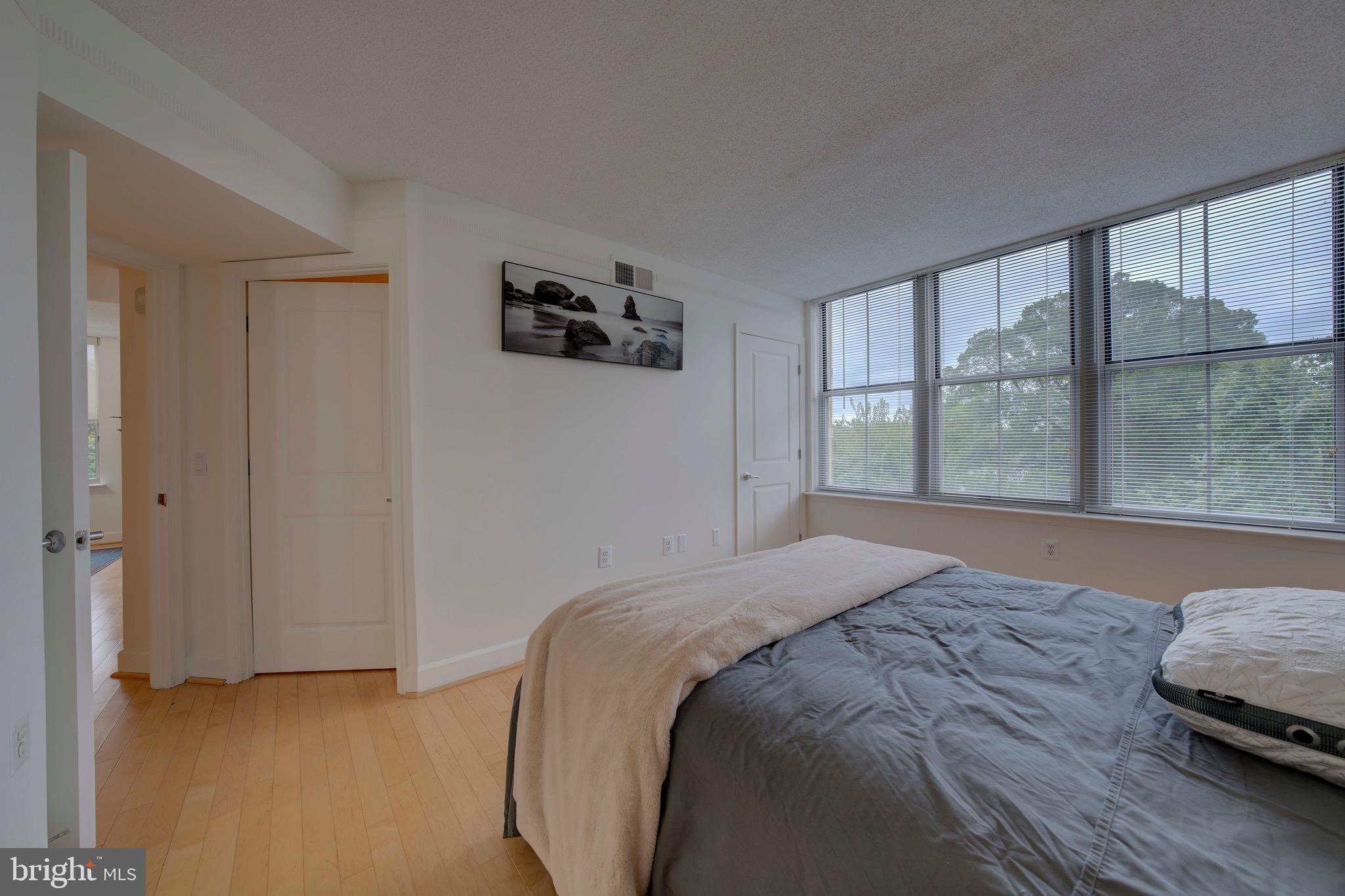 11800 Sunset Hills Road, Unit 222 Reston, VA 20190 - Photo 24 of 70 a bedroom with a bed and a large window