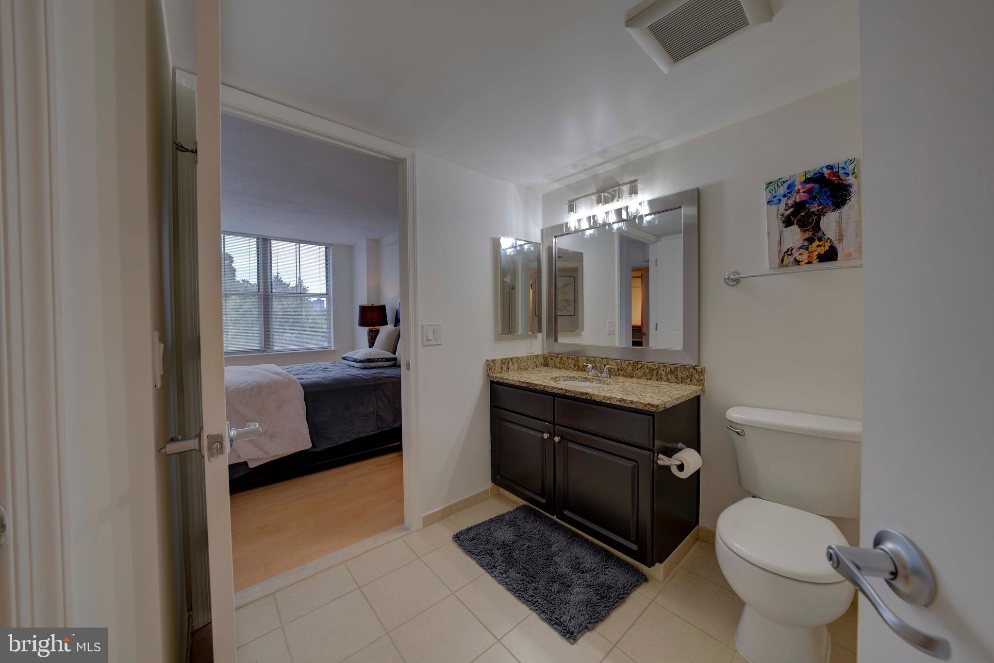 11800 Sunset Hills Road, Unit 222 Reston, VA 20190 - Photo 30 of 70 a bathroom with a toilet a sink and a mirror