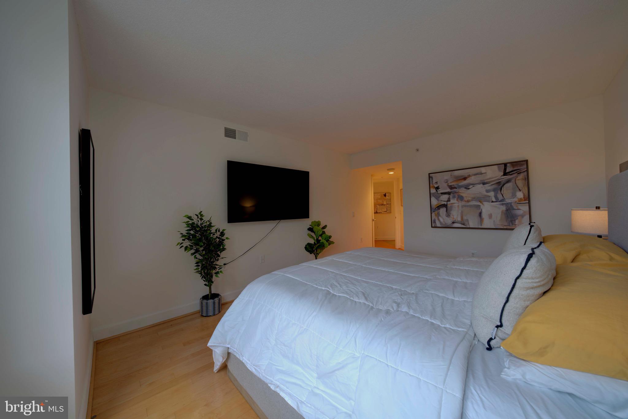 11800 Sunset Hills Road, Unit 222 Reston, VA 20190 - Photo 35 of 70 a bedroom with a bed and a flat screen tv
