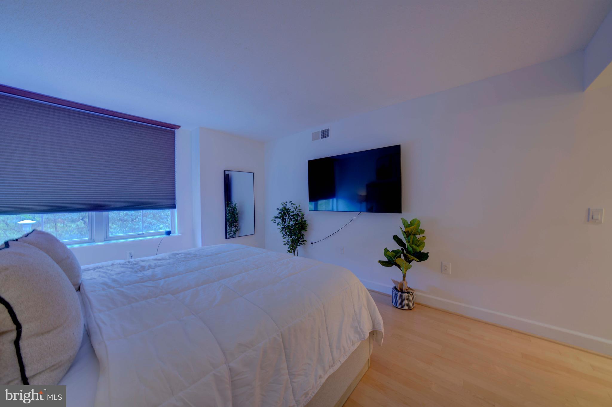 11800 Sunset Hills Road, Unit 222 Reston, VA 20190 - Photo 36 of 70 a bed room with a bed and a television