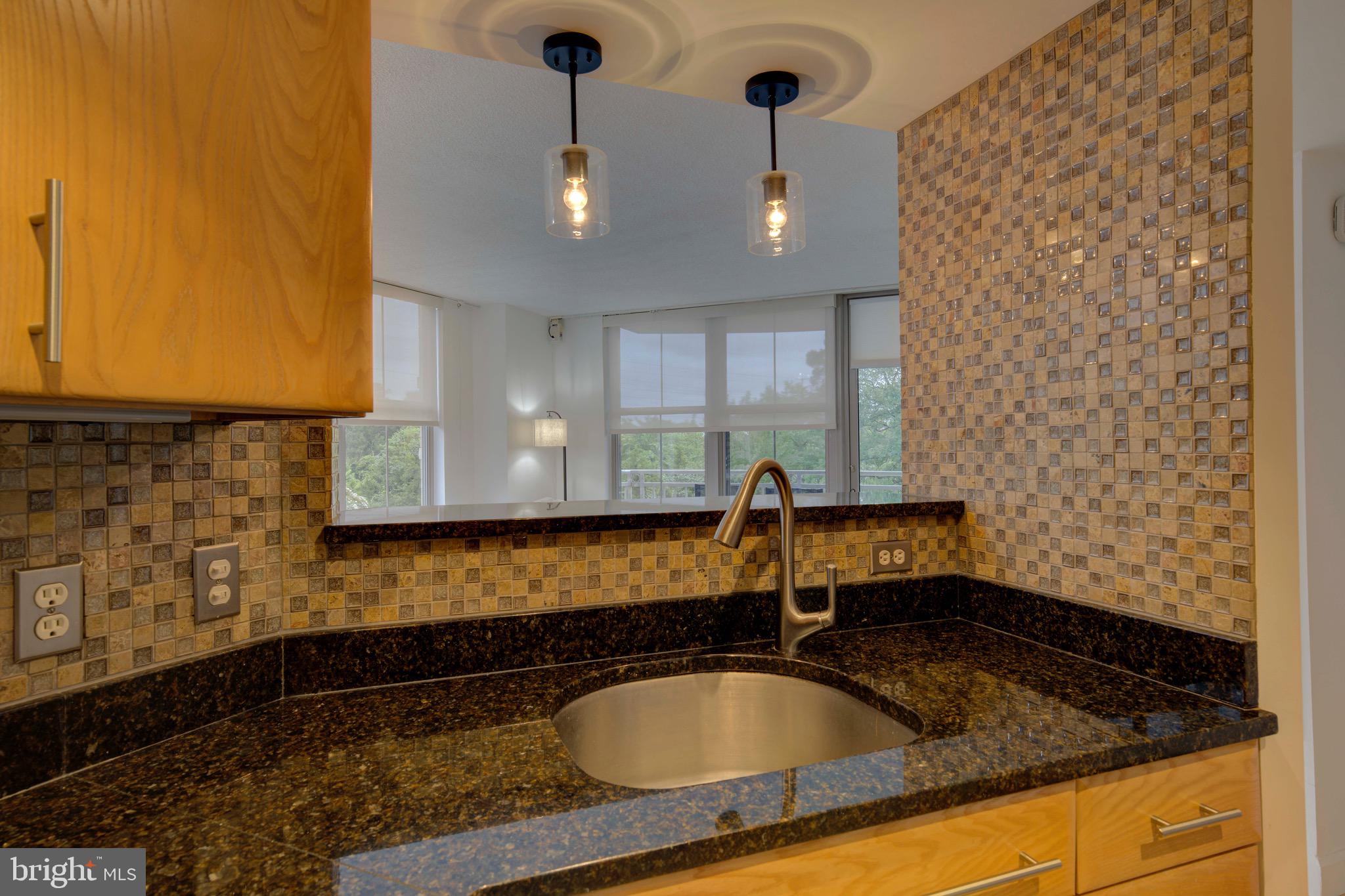 11800 Sunset Hills Road, Unit 222 Reston, VA 20190 - Photo 8 of 70 a bathroom with a granite countertop sink and a bathtub
