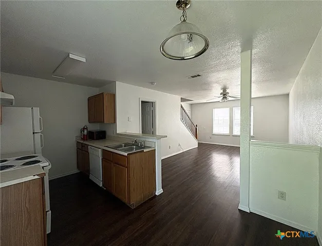 a kitchen with stainless steel appliances a stove and a refrigerator