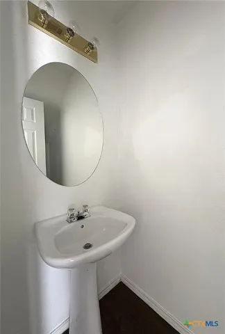 a bathroom with a sink and mirror
