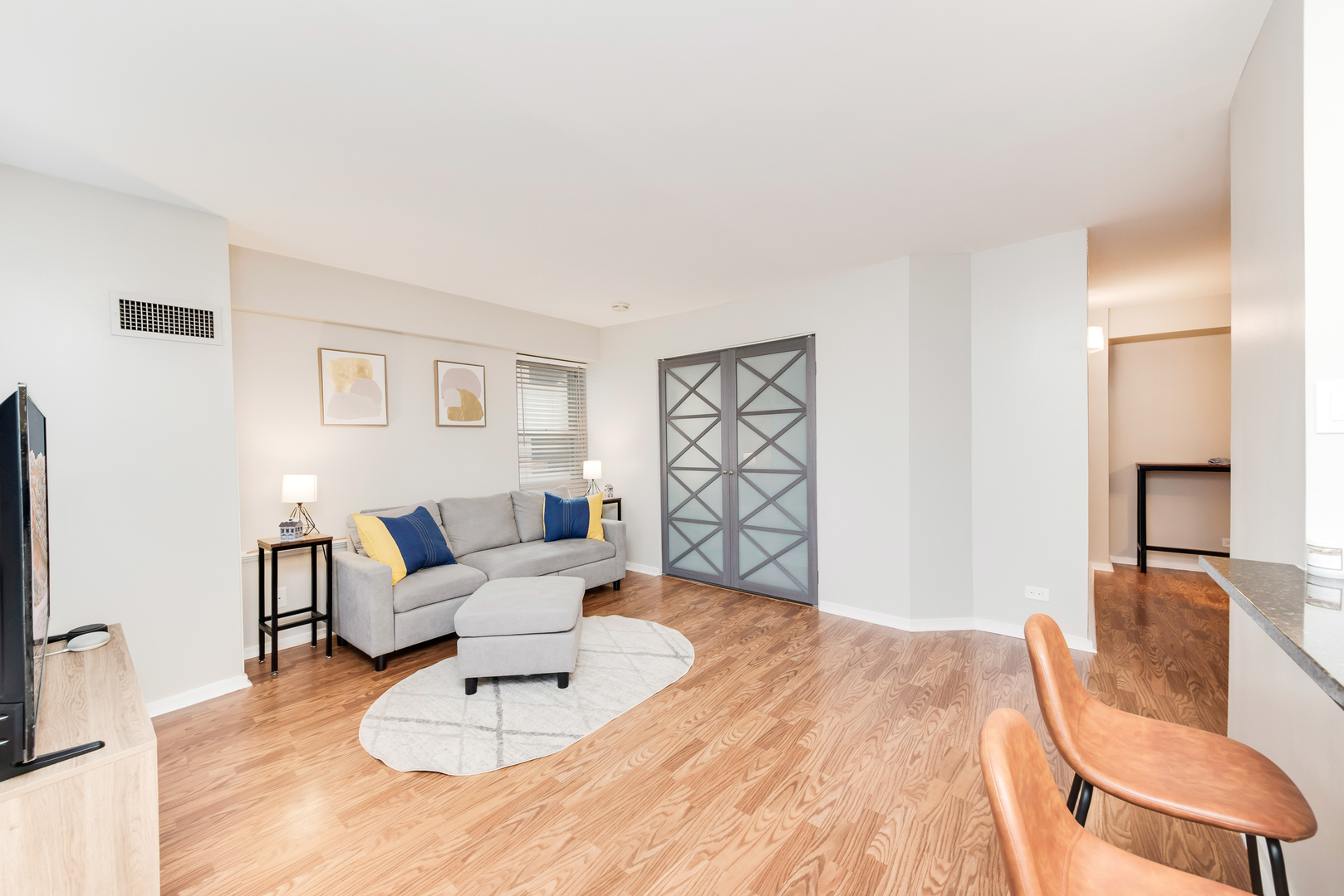 40 East 9th Street, Unit 715 Chicago, IL 60605 - Photo 4 of 19 a living room with furniture and a flat screen tv