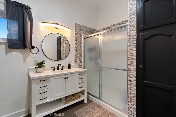 a bathroom with a sink a toilet and a mirror