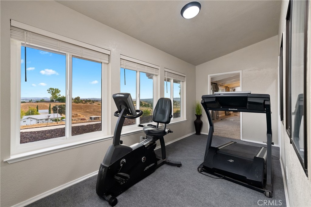 2245 Rancho Lomas Way San Miguel, CA 93451 - Photo 17 of 52 a room with gym equipment and a large window