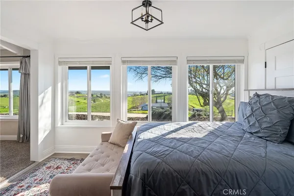 a bedroom with a bed and a couch