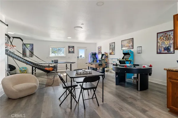 a view of a dining room with furniture and wooden floor