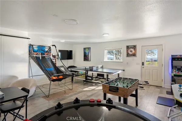a living room with furniture a air conditioner and a window