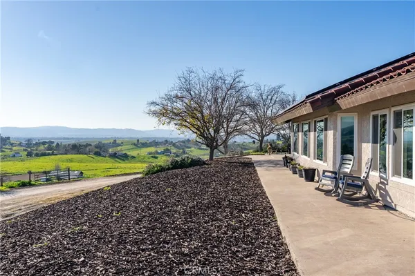 a view of a house with a swimming pool and sitting area