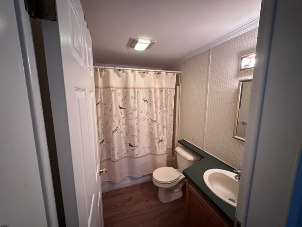 a bathroom with a toilet a sink and shower