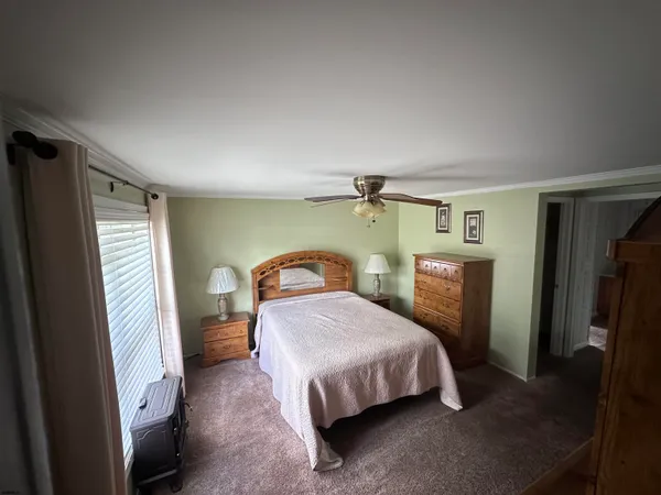 a bed sitting in a room next to a window