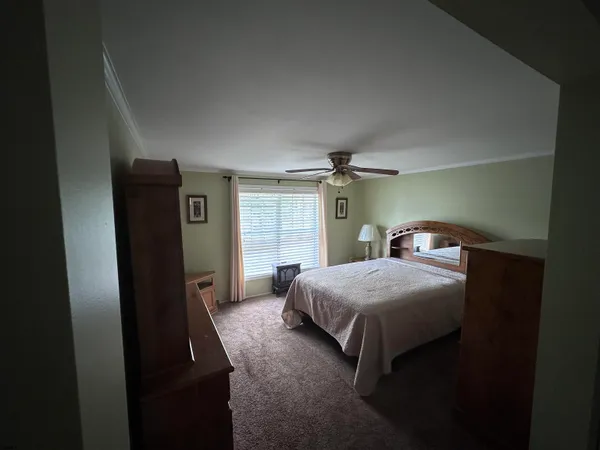 a bedroom with a bed and a window