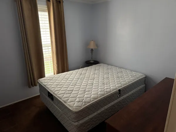 a bed sitting in a bedroom next to a window