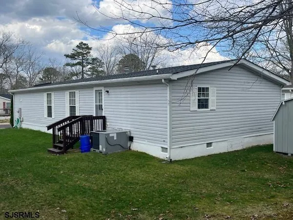 a view of a backyard with a garden and deck
