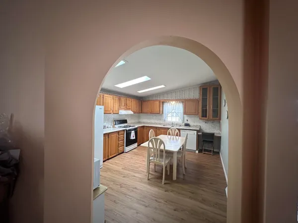 a view of a dining room with furniture and wooden floor