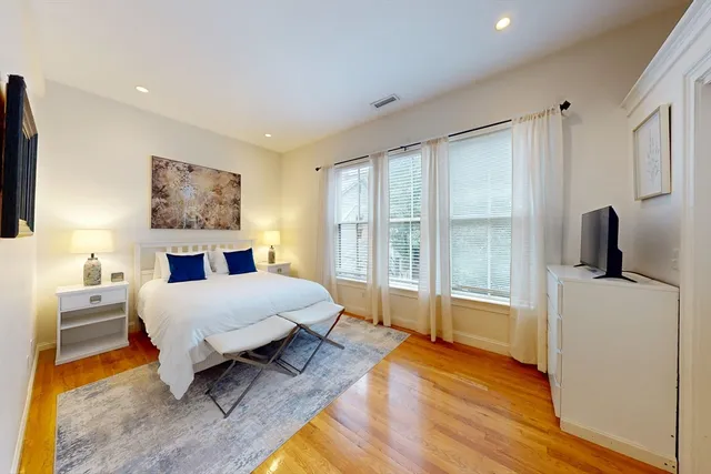 a spacious bedroom with a bed and a large window