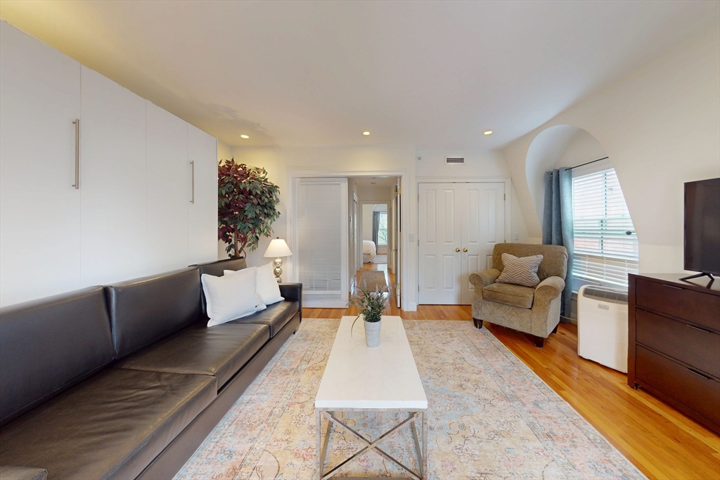 2 Harvard Square, Unit 2FURNISHED Brookline, MA 02445 - Photo 15 of 21 a living room with furniture and a couch