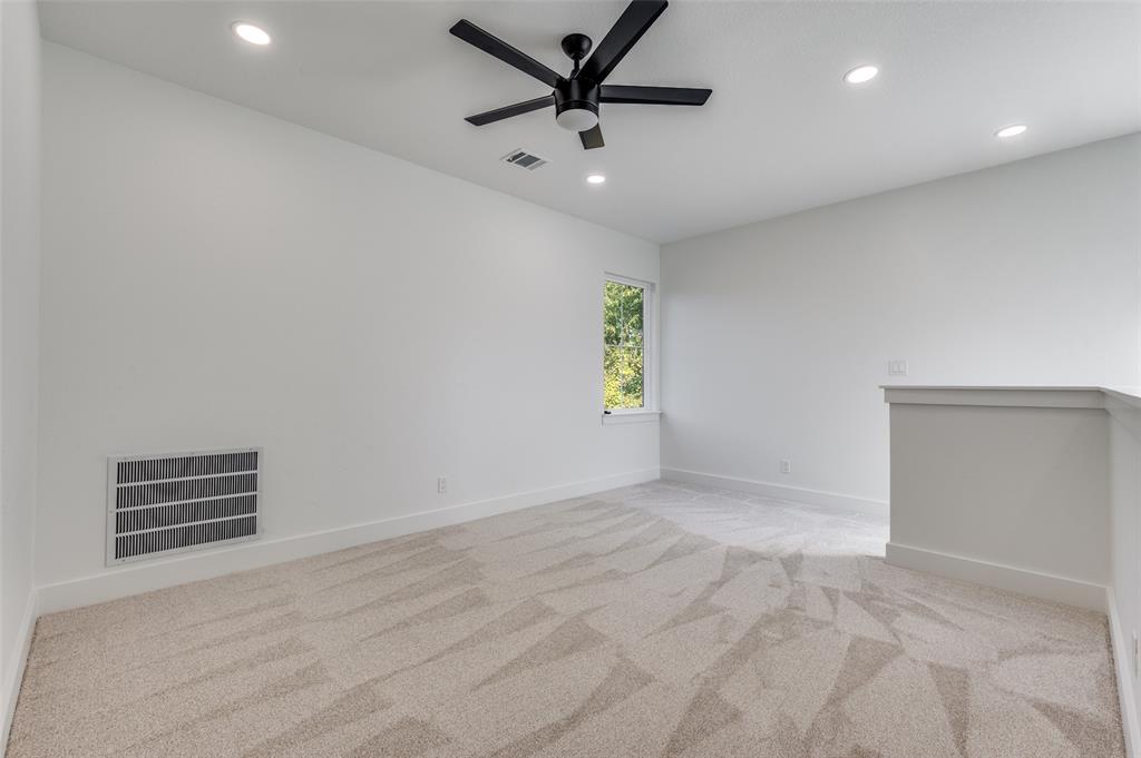 1013 Murphy Street Gainesville, TX 76240 - Photo 9 of 22 an empty room with windows and fan