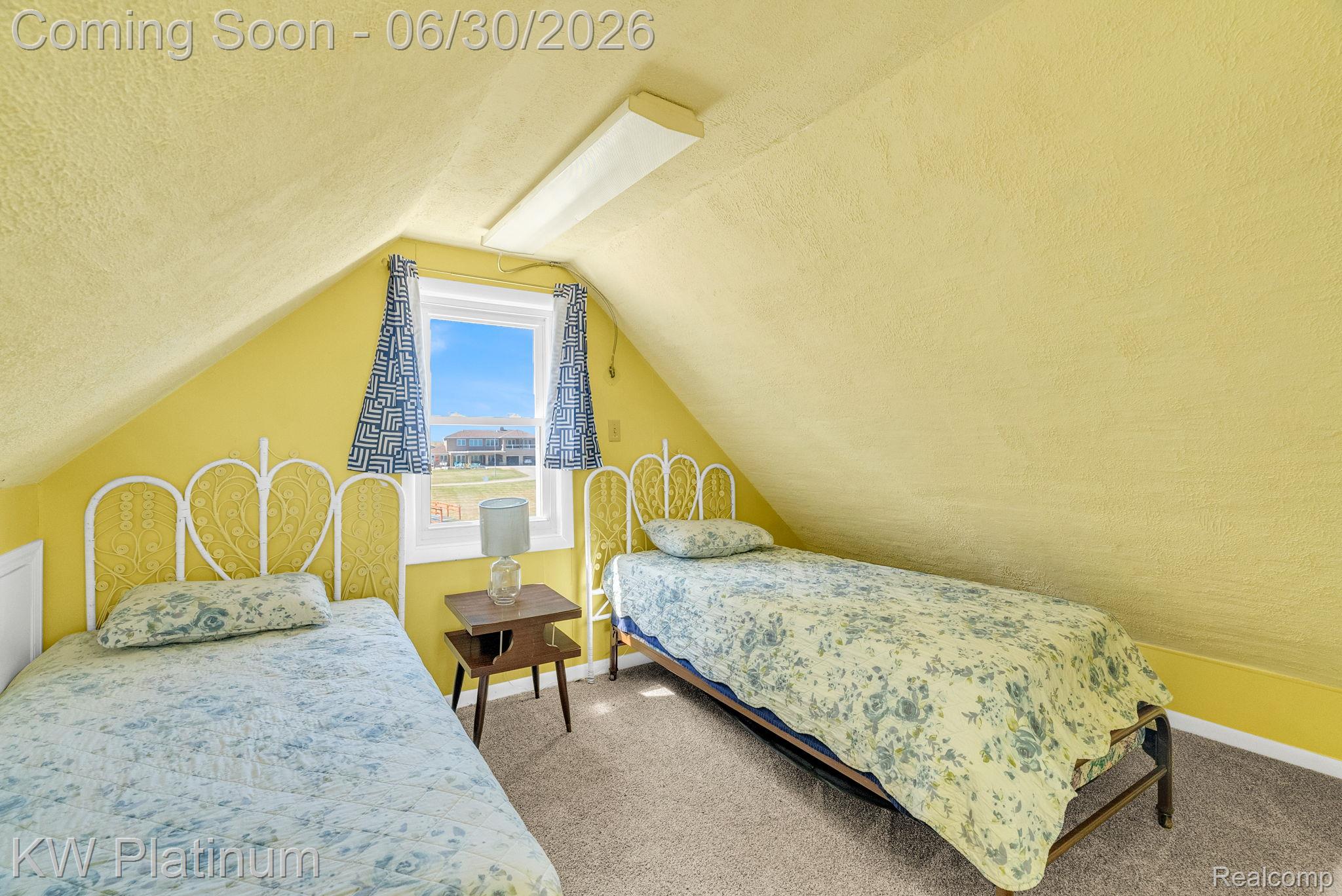 2235 South Lake Shore Road Harbor Beach, MI 48441 - Photo 76 of 99 Attic room featuring a window, textured yellow walls, and a sloped ceiling