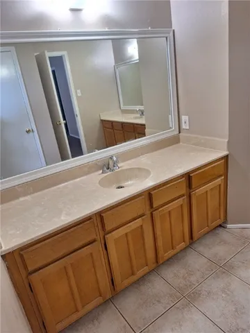 a bathroom with a sink vanity and mirror