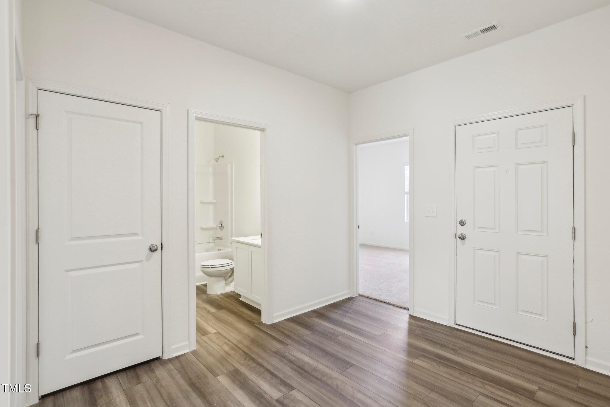 137 Gladstone Loop Clayton, NC 27520 - Photo 16 of 35 an empty room with wooden floor