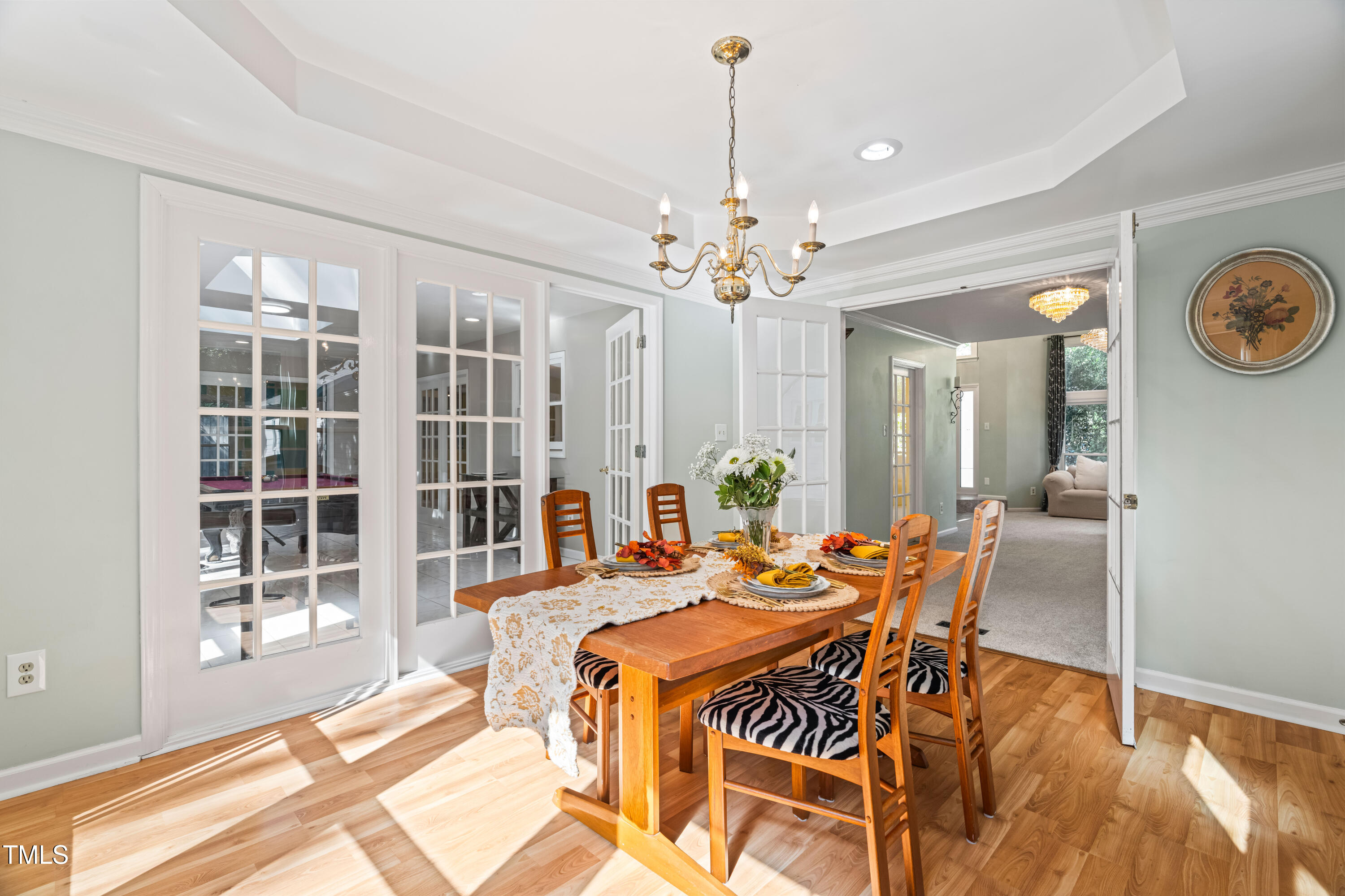 1106 Wellstone Circle Apex, NC 27502 - Photo 16 of 67 a view of a dining room with furniture a chandelier and wooden floor