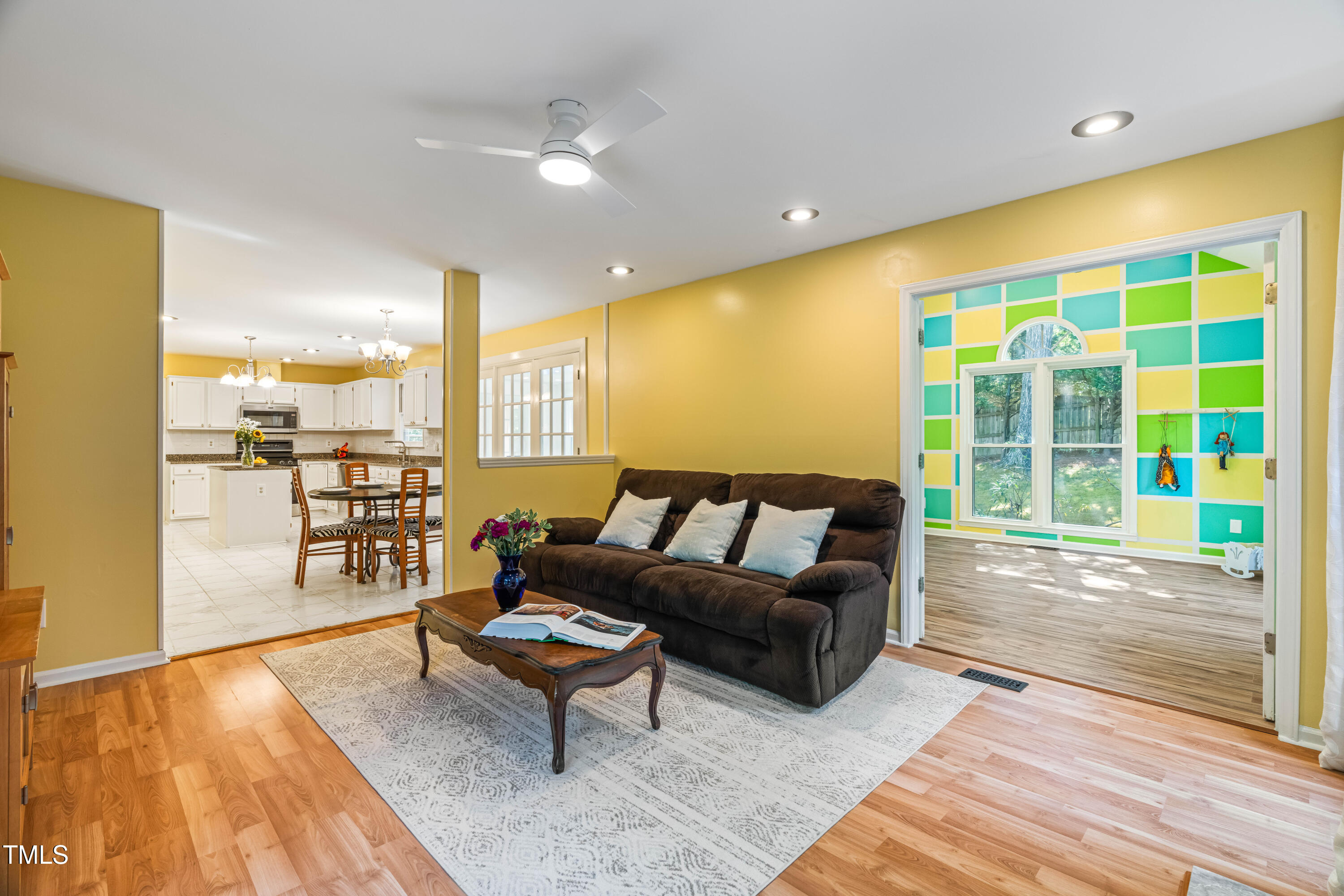 1106 Wellstone Circle Apex, NC 27502 - Photo 24 of 67 a living room with furniture and a floor to ceiling window