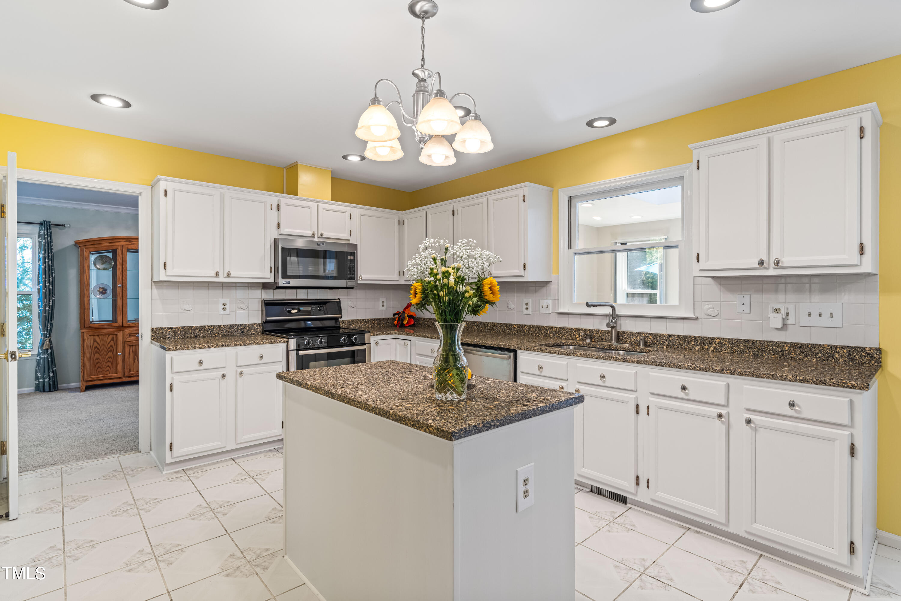 1106 Wellstone Circle Apex, NC 27502 - Photo 29 of 67 a kitchen with stainless steel appliances granite countertop a sink dishwasher and white cabinets with a granite countertops