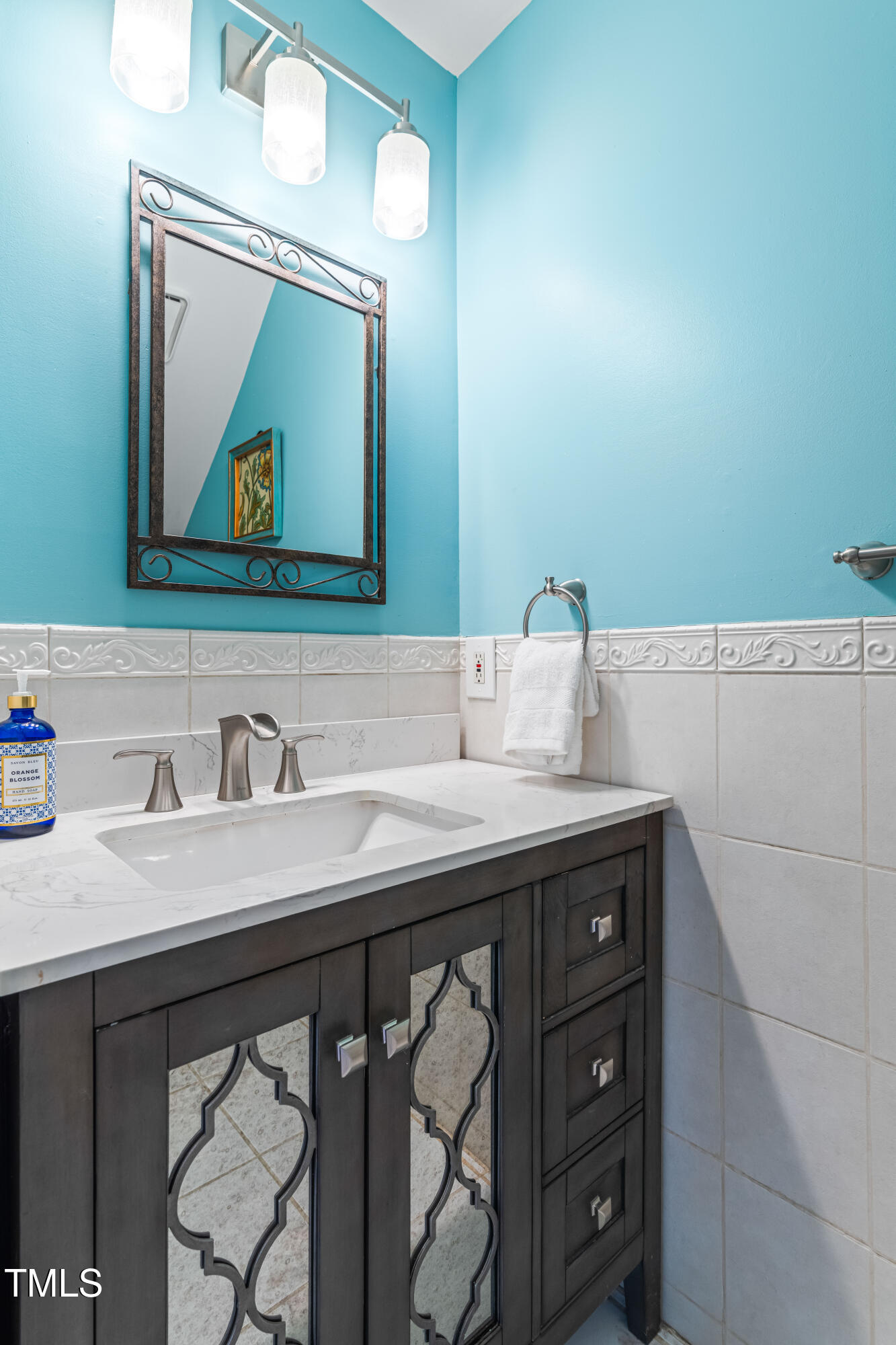 1106 Wellstone Circle Apex, NC 27502 - Photo 34 of 67 a bathroom with a granite countertop sink a mirror and vanity