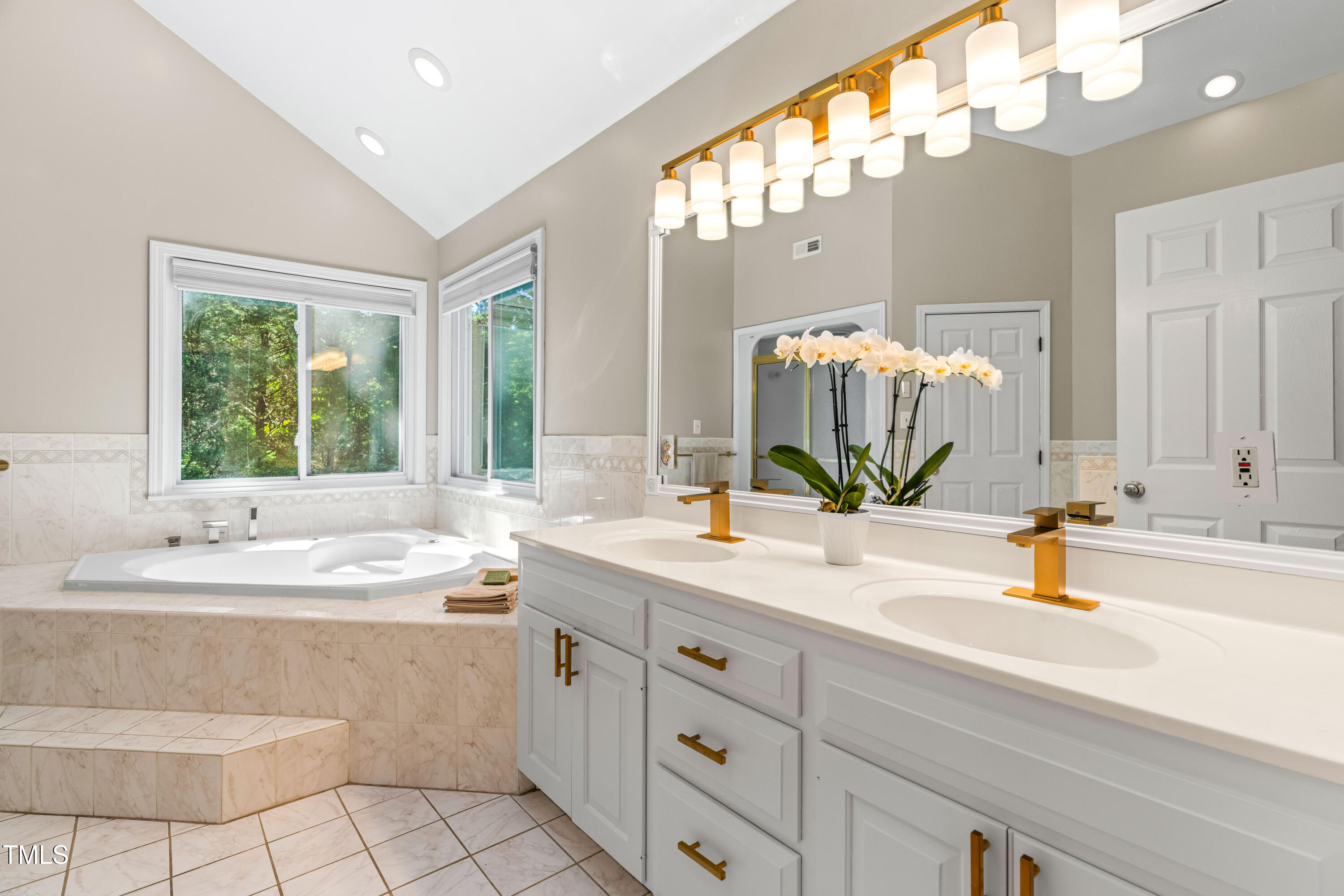 1106 Wellstone Circle Apex, NC 27502 - Photo 40 of 67 a bathroom with a sink double vanity mirror and bathtub