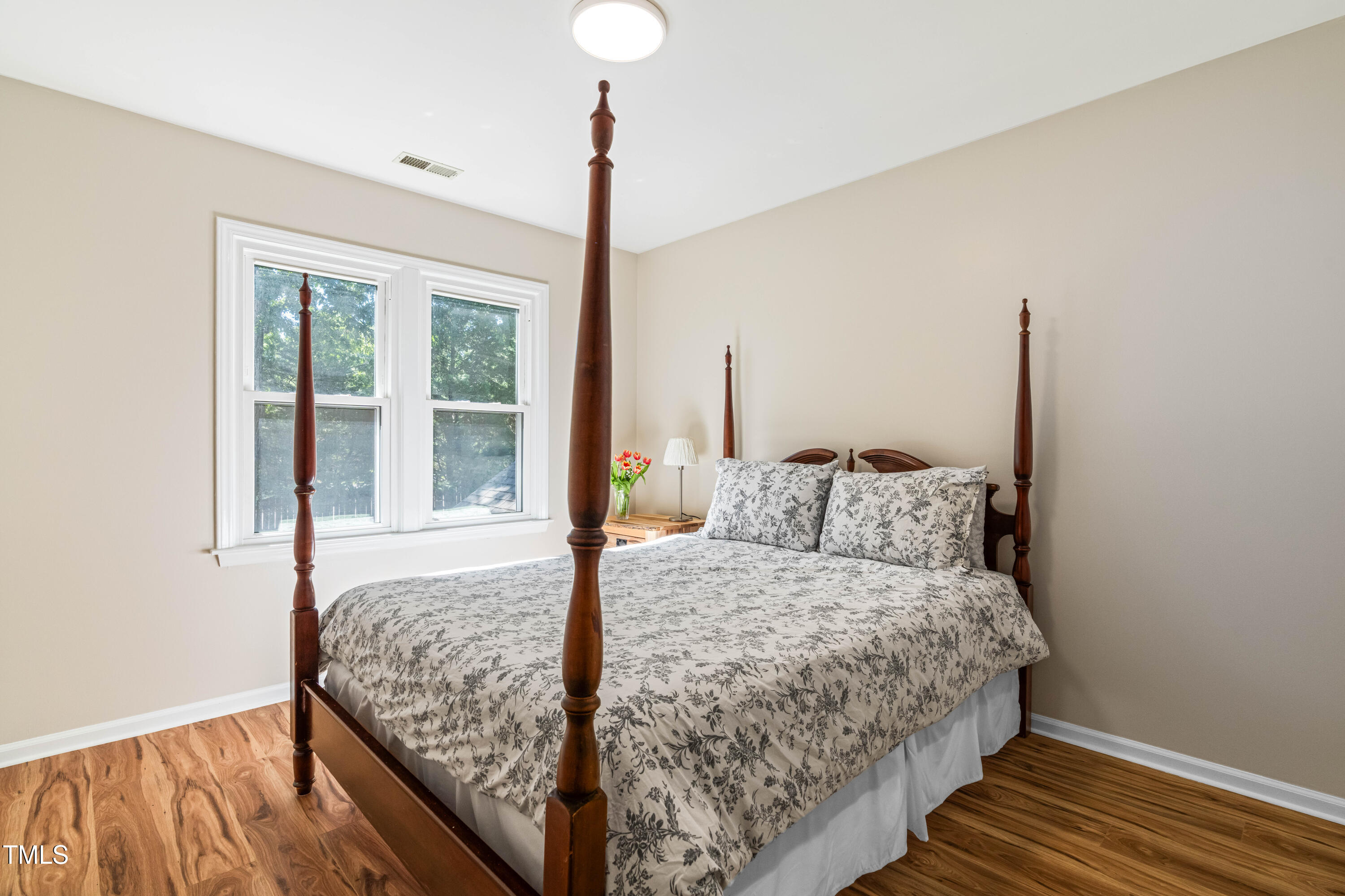 1106 Wellstone Circle Apex, NC 27502 - Photo 46 of 67 a bedroom with a bed and wooden floor