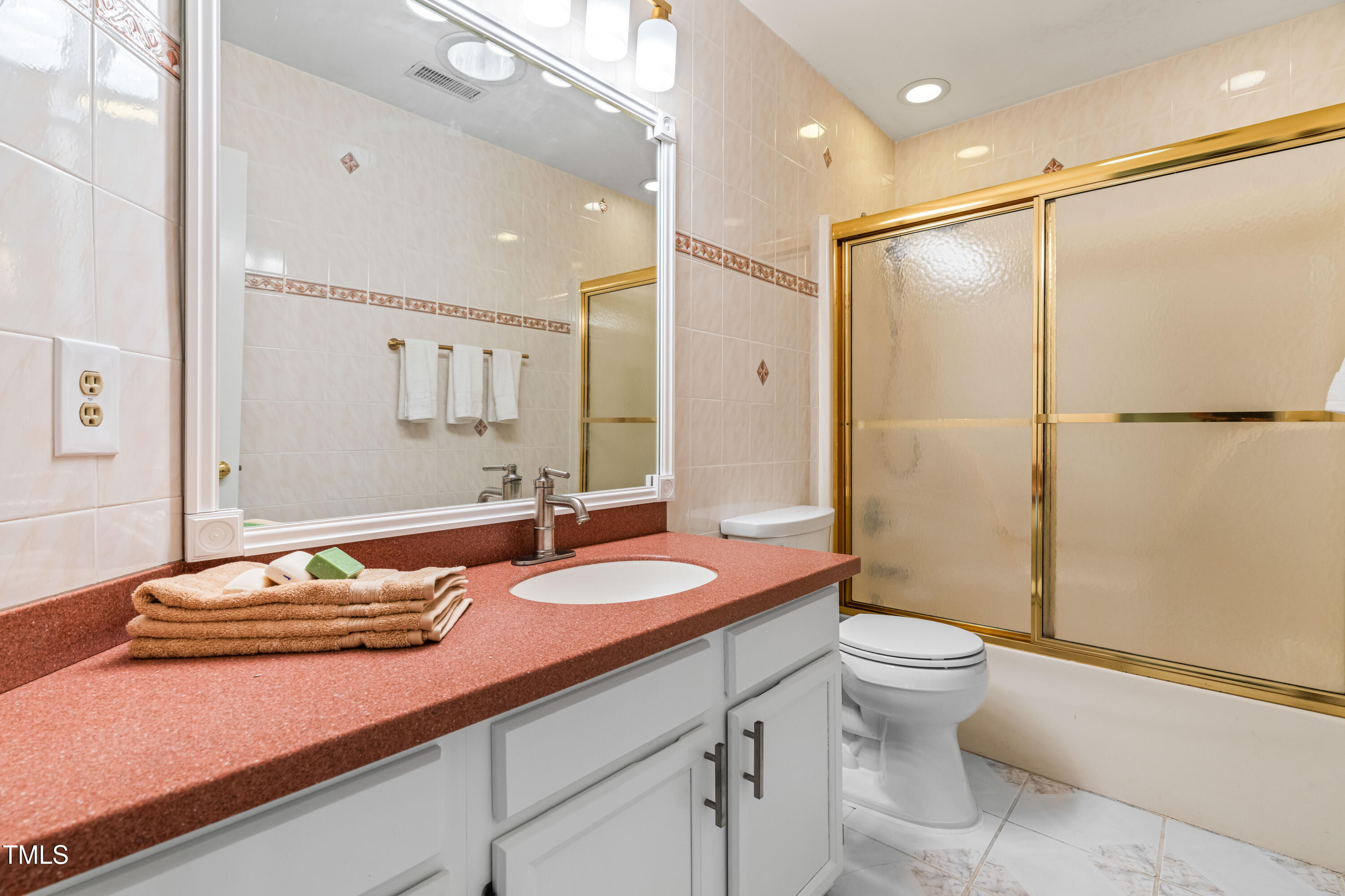 1106 Wellstone Circle Apex, NC 27502 - Photo 49 of 67 a bathroom with a sink a toilet and shower