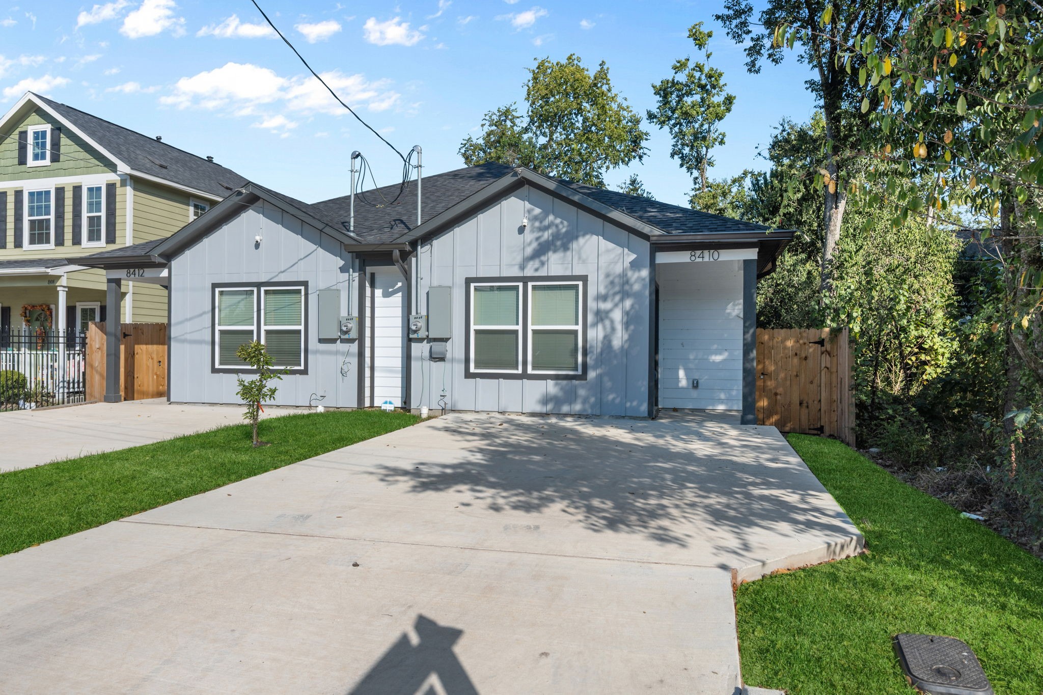 a front view of a house with a yard and trees