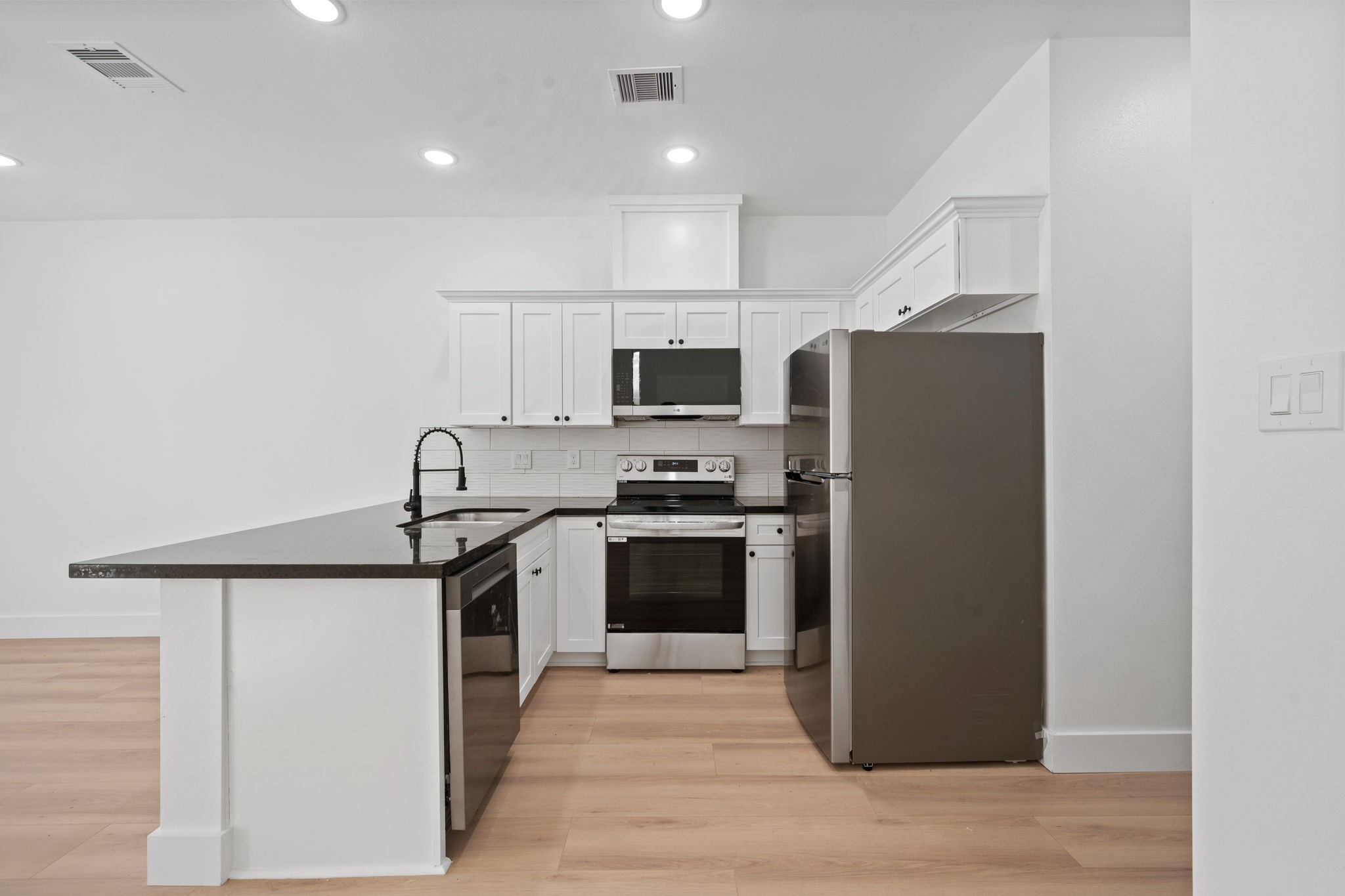 8410 Sunnyhill Street Houston, TX 77088 - Photo 13 of 20 a kitchen with stainless steel appliances granite countertop a refrigerator a stove top oven a sink and dishwasher