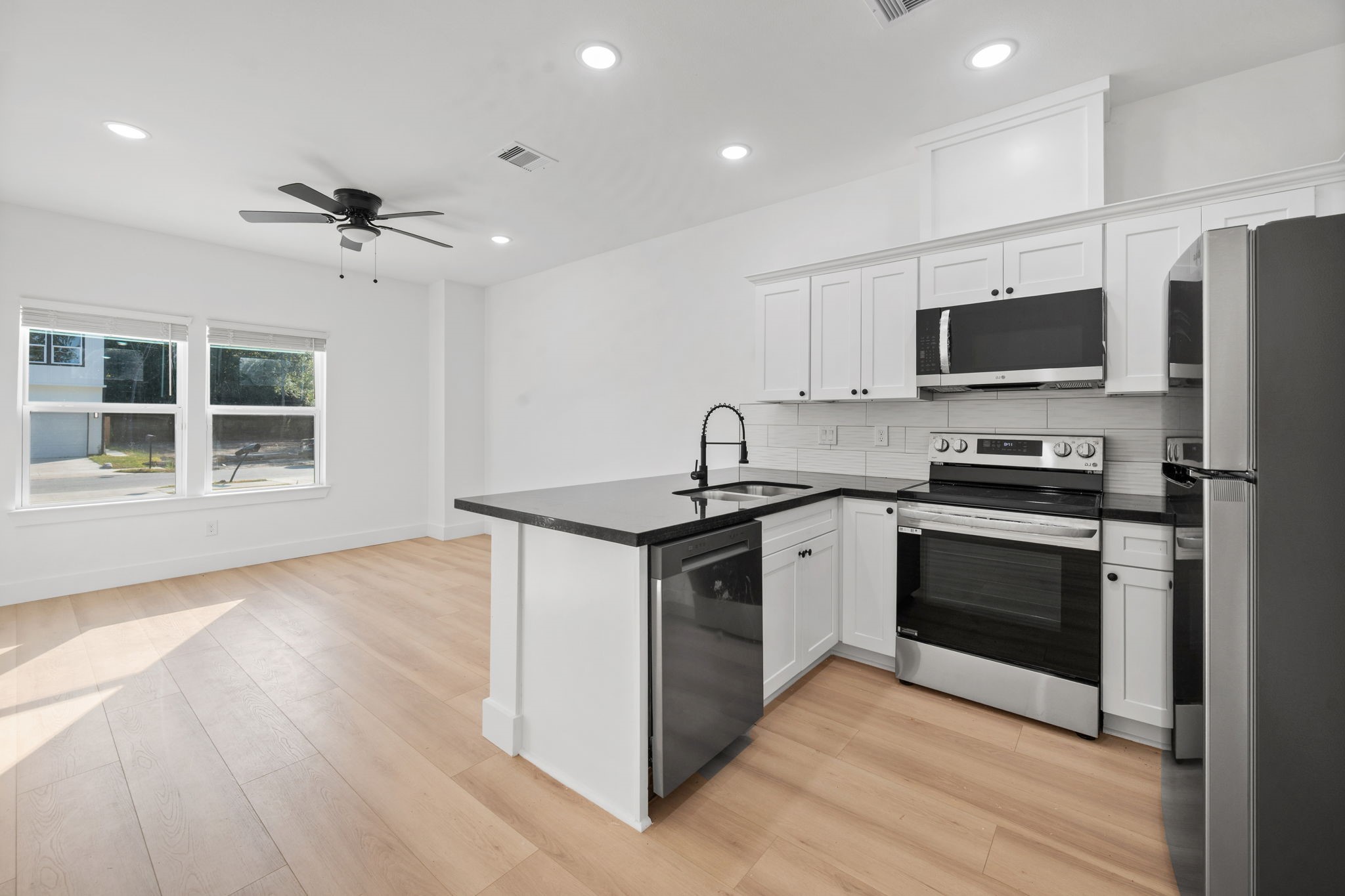 8410 Sunnyhill Street Houston, TX 77088 - Photo 14 of 20 a kitchen with stainless steel appliances granite countertop a stove a refrigerator and a microwave