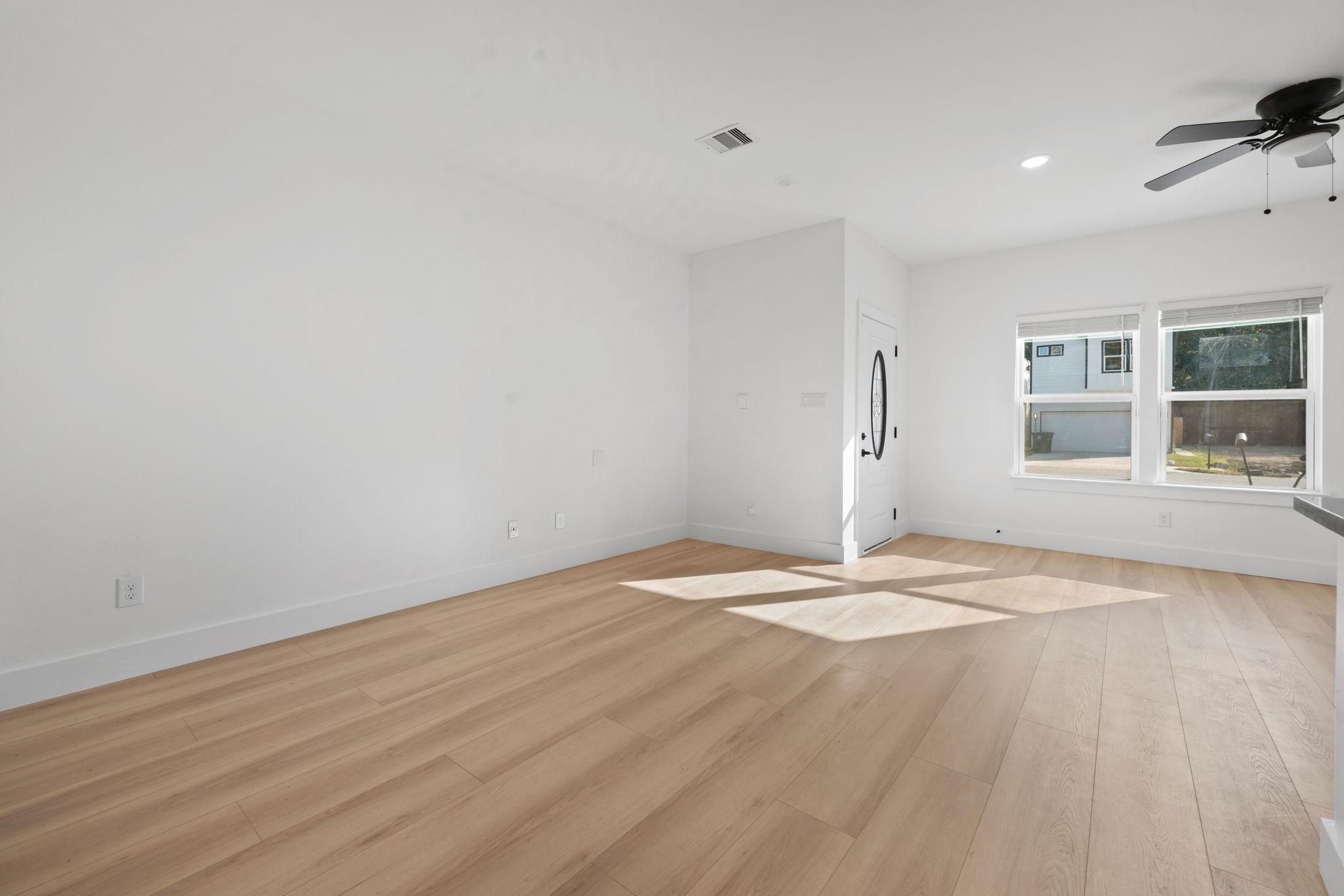8410 Sunnyhill Street Houston, TX 77088 - Photo 15 of 20 a view of empty room with wooden floor and fireplace