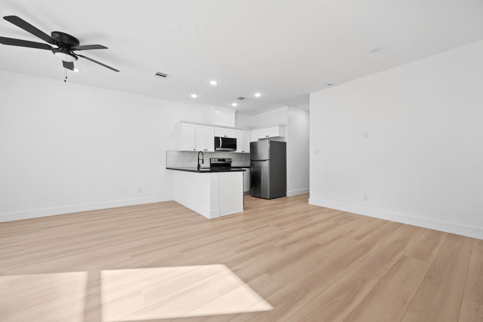8410 Sunnyhill Street Houston, TX 77088 - Photo 17 of 20 a view of a kitchen with a sink and a refrigerator