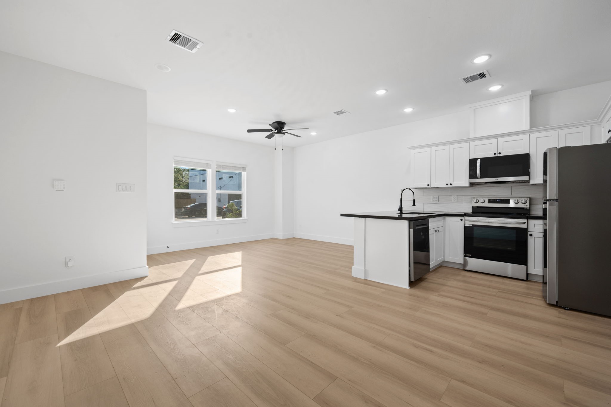 8410 Sunnyhill Street Houston, TX 77088 - Photo 18 of 20 a kitchen with stainless steel appliances a refrigerator and a stove top oven
