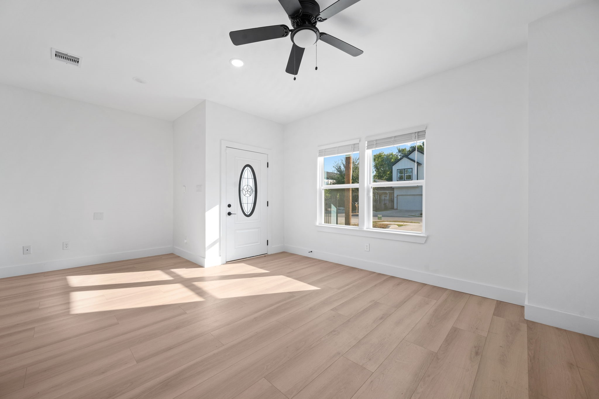 8410 Sunnyhill Street Houston, TX 77088 - Photo 20 of 20 a view of an empty room with window and wooden floor