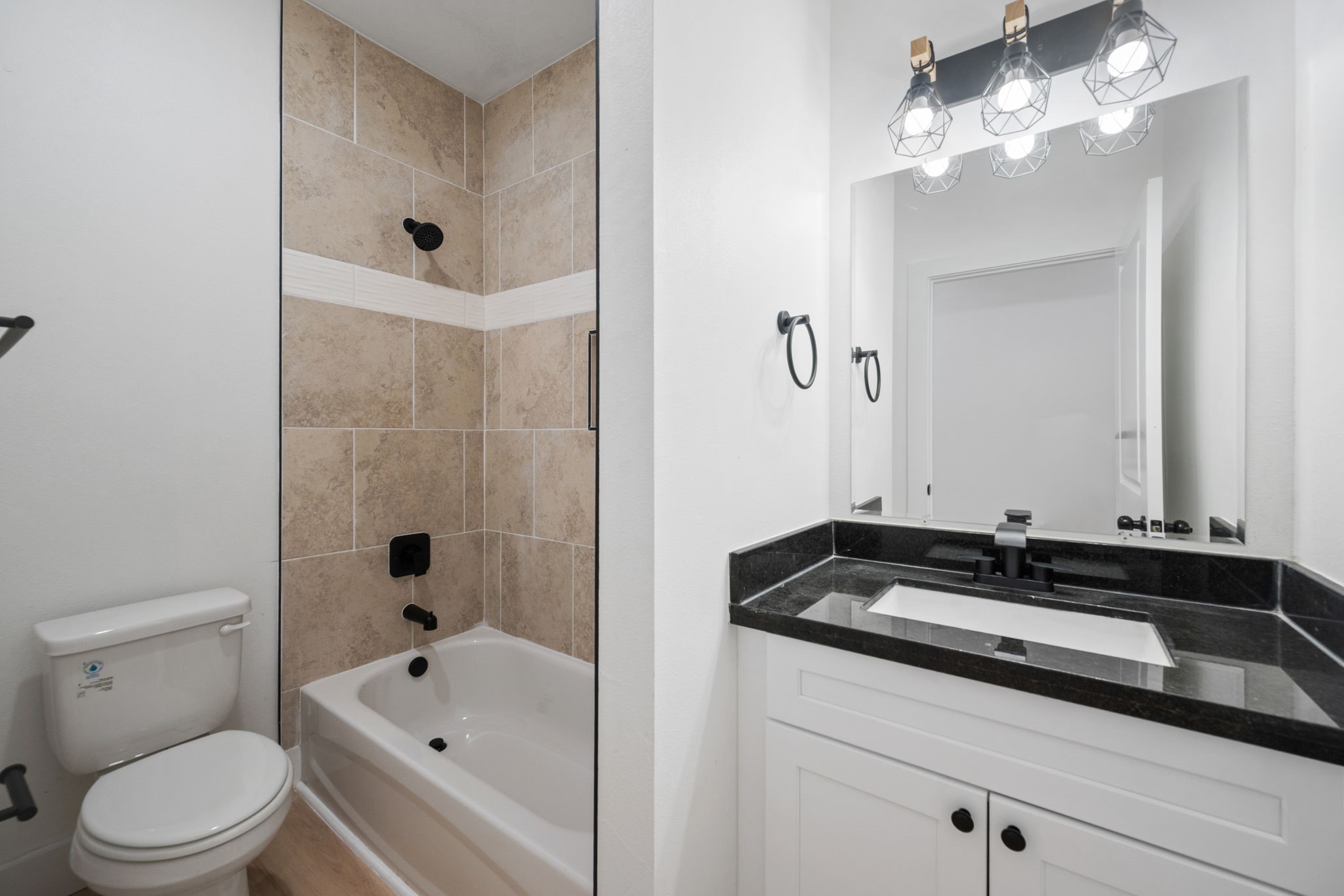 8410 Sunnyhill Street Houston, TX 77088 - Photo 3 of 20 a bathroom with a sink a toilet and a mirror