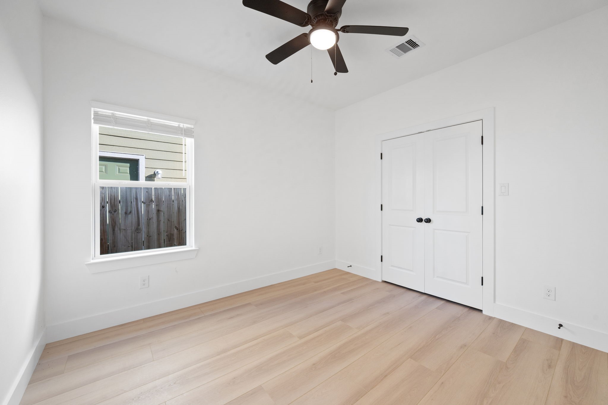 8410 Sunnyhill Street Houston, TX 77088 - Photo 4 of 20 a view of an empty room with a window