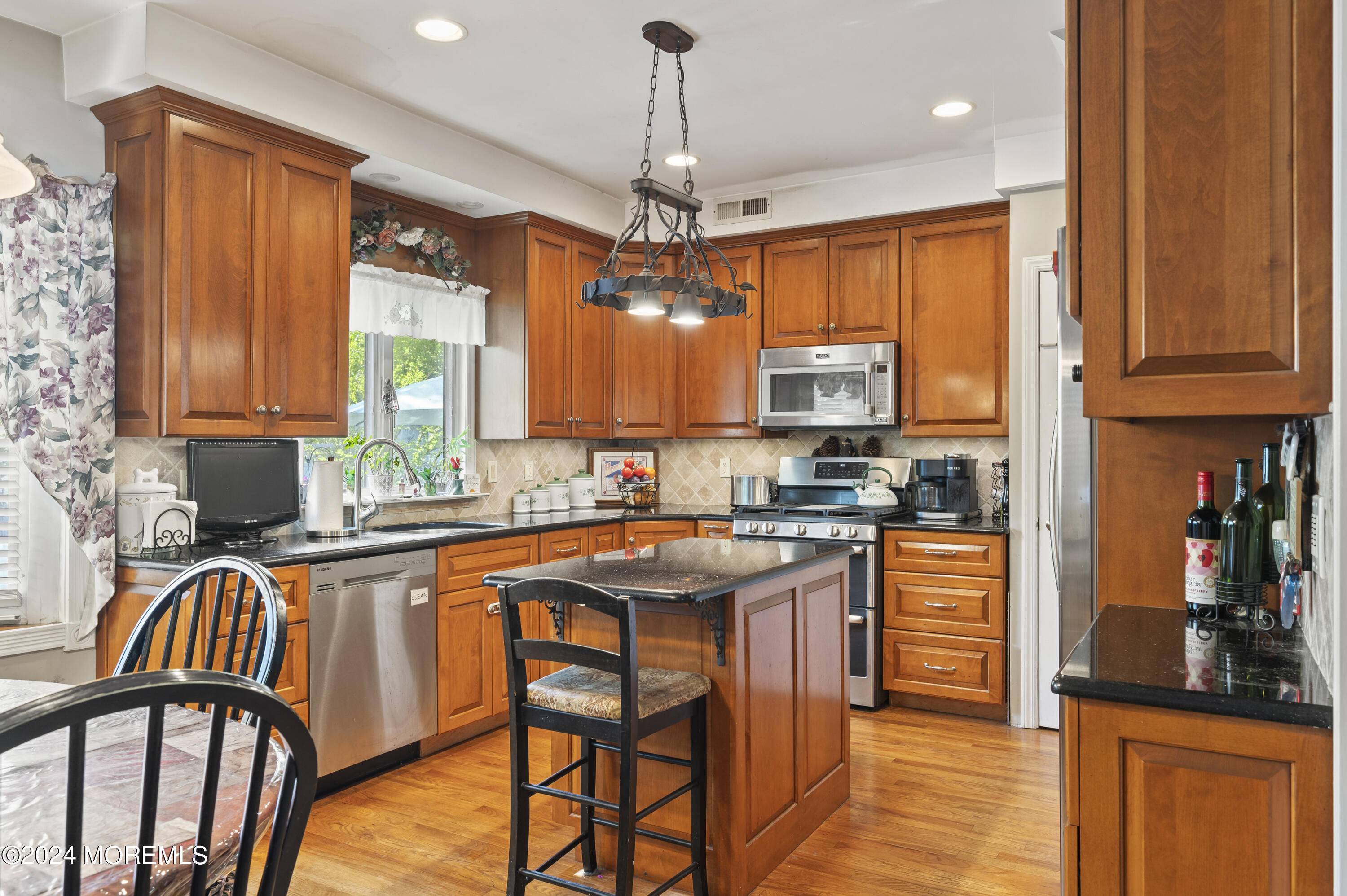 114 Andrew Lane Brick, NJ 08724 - Photo 11 of 54 a kitchen with stainless steel appliances granite countertop a stove top oven a sink dishwasher and cabinets with wooden floor