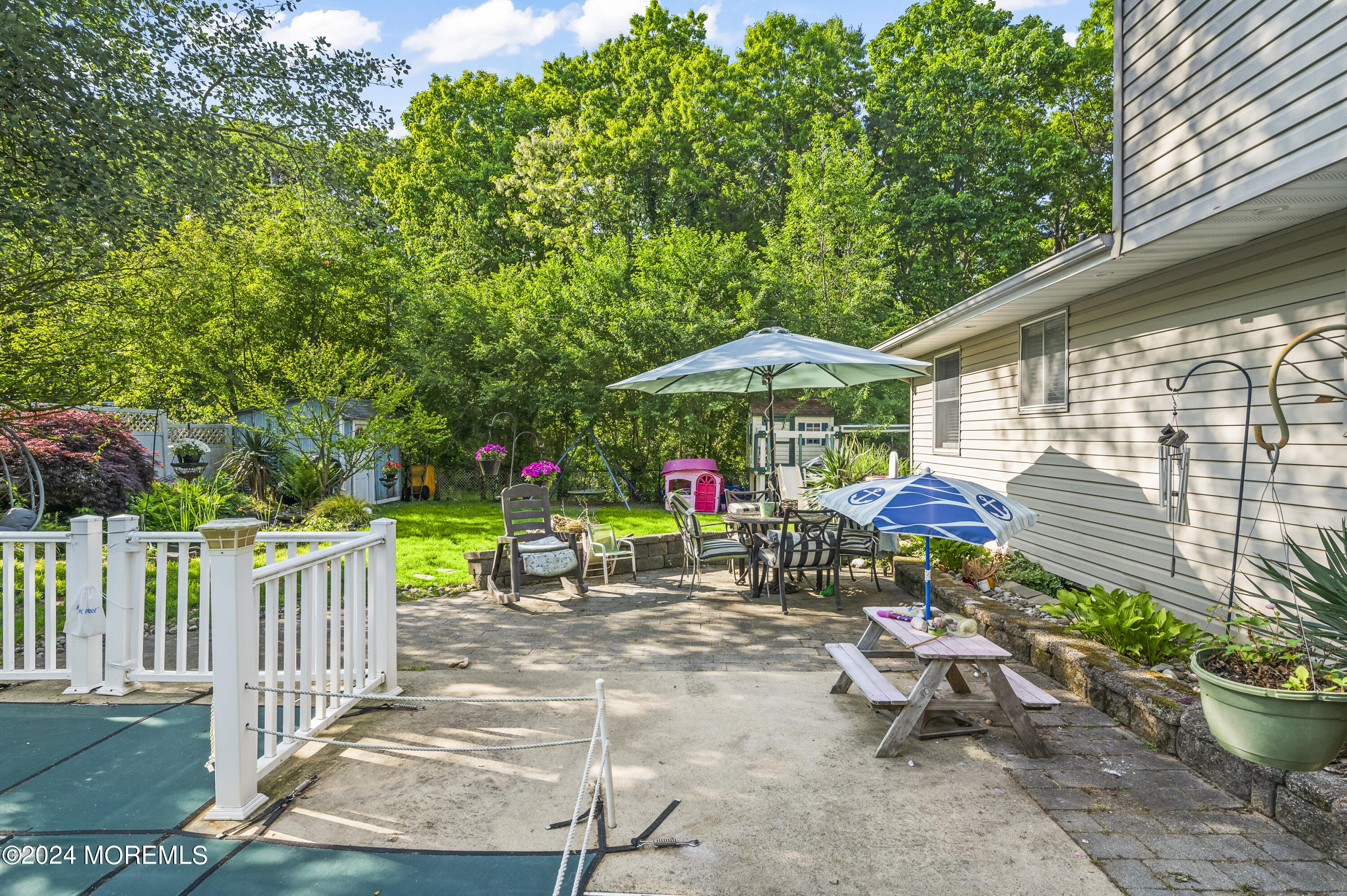 114 Andrew Lane Brick, NJ 08724 - Photo 23 of 54 a view of a chairs and tables in the back yard of the house