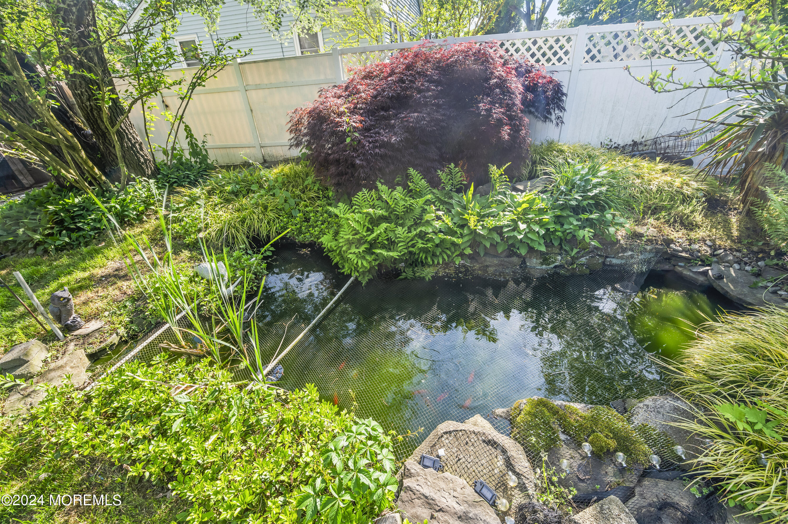114 Andrew Lane Brick, NJ 08724 - Photo 44 of 54 a backyard of a house with lots of green space and a fountain