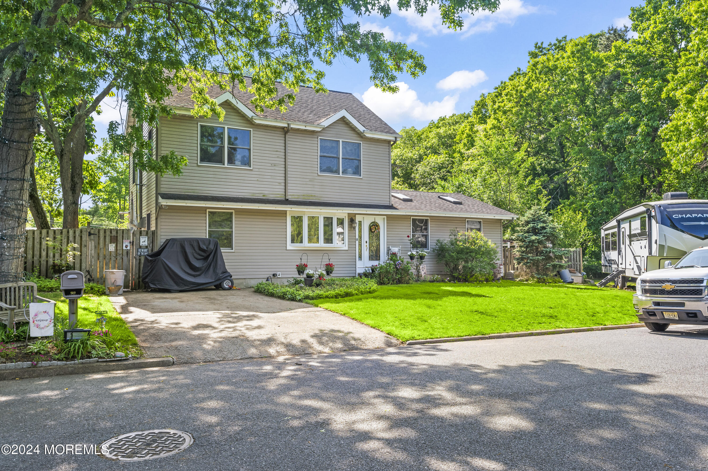 114 Andrew Lane Brick, NJ 08724 - Photo 5 of 54 a front view of a house with a yard and garage